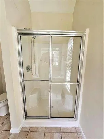 a bathroom with a glass shower door