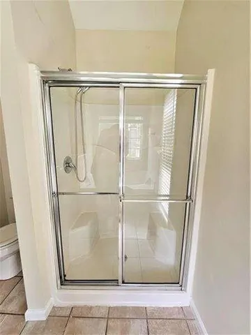 a bathroom with a glass shower door
