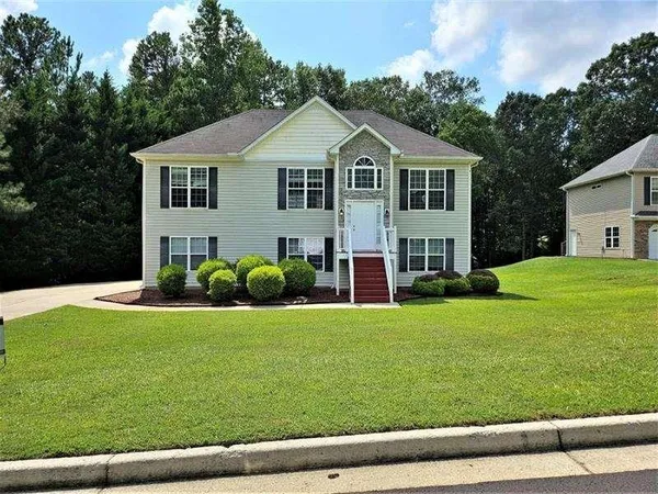 a front view of a house with a yard and garage