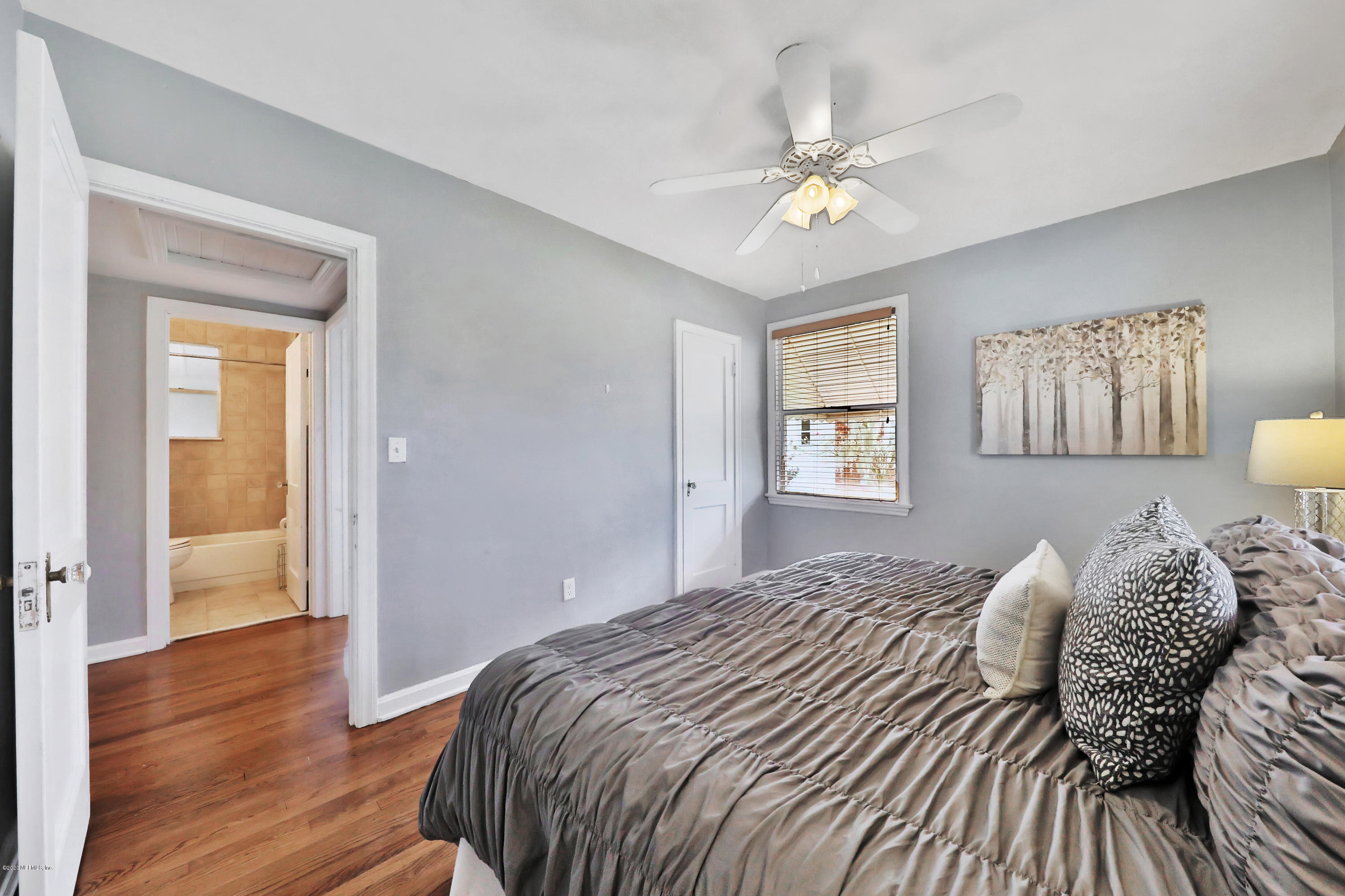 4033 Dover Road Jacksonville, FL 32207 - Photo 16 of 25 a bedroom with a bed and wooden floor