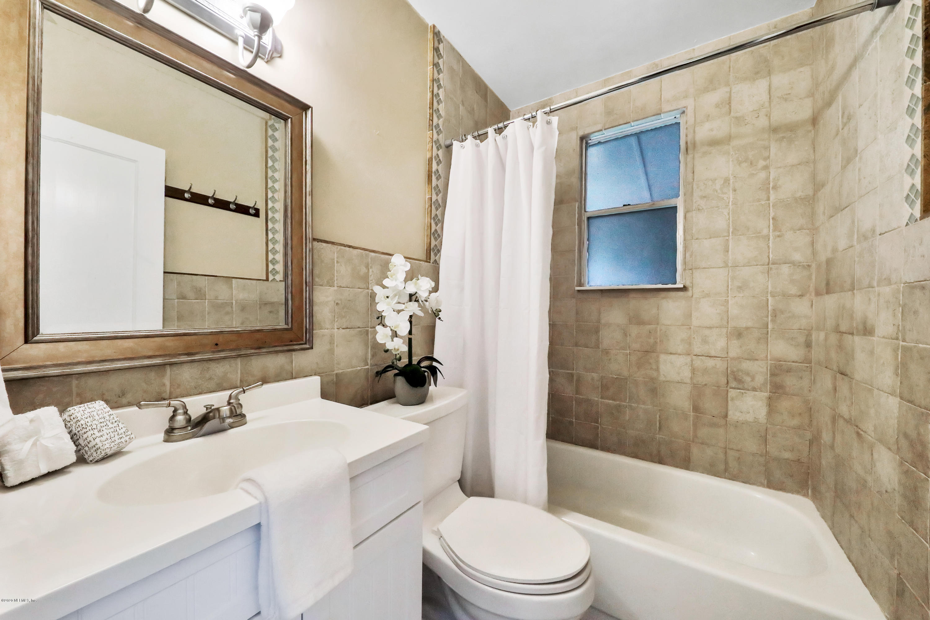 4033 Dover Road Jacksonville, FL 32207 - Photo 17 of 25 a bathroom with a sink a toilet and shower