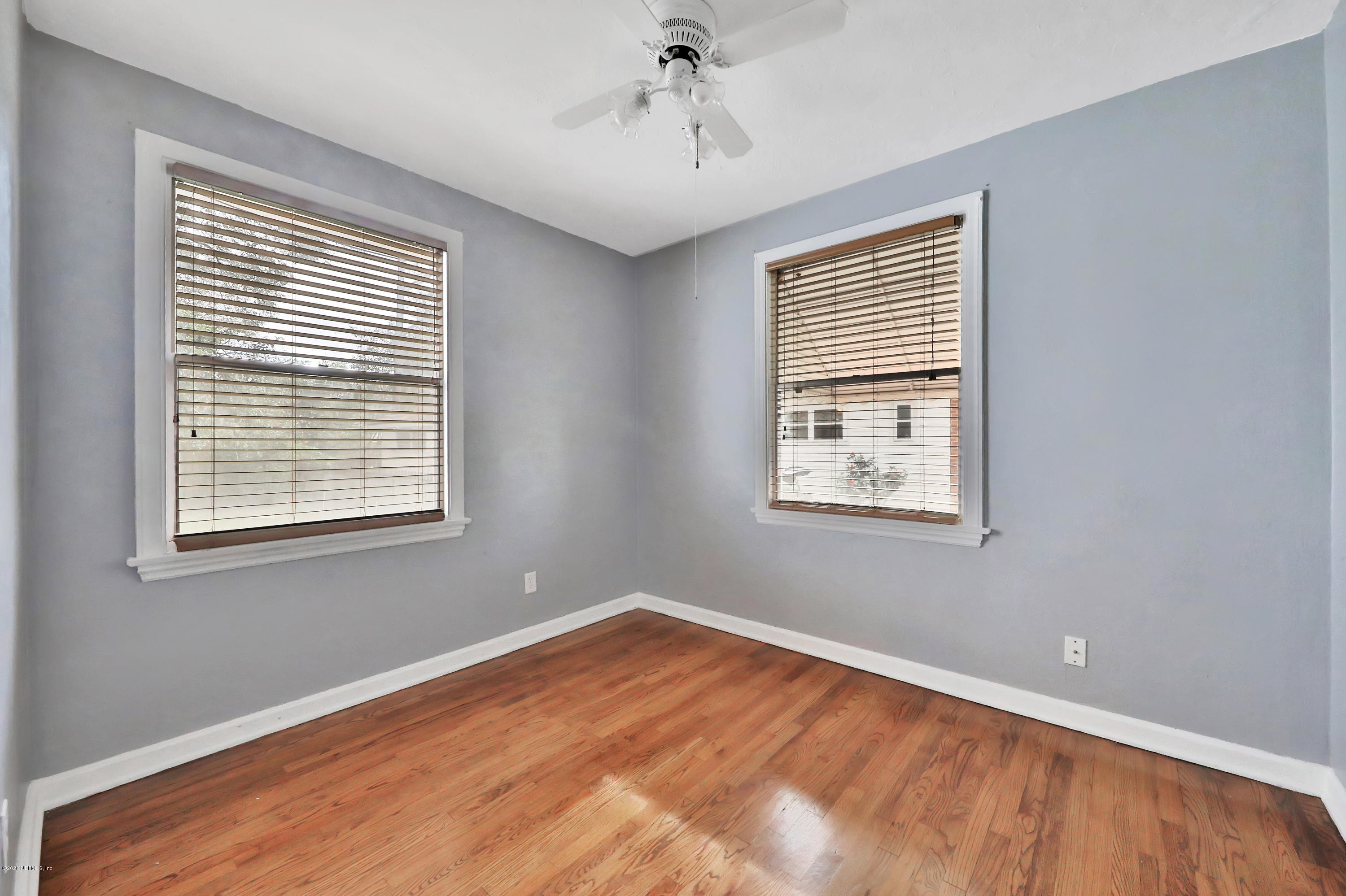4033 Dover Road Jacksonville, FL 32207 - Photo 20 of 25 a view of an empty room with wooden floor and a window