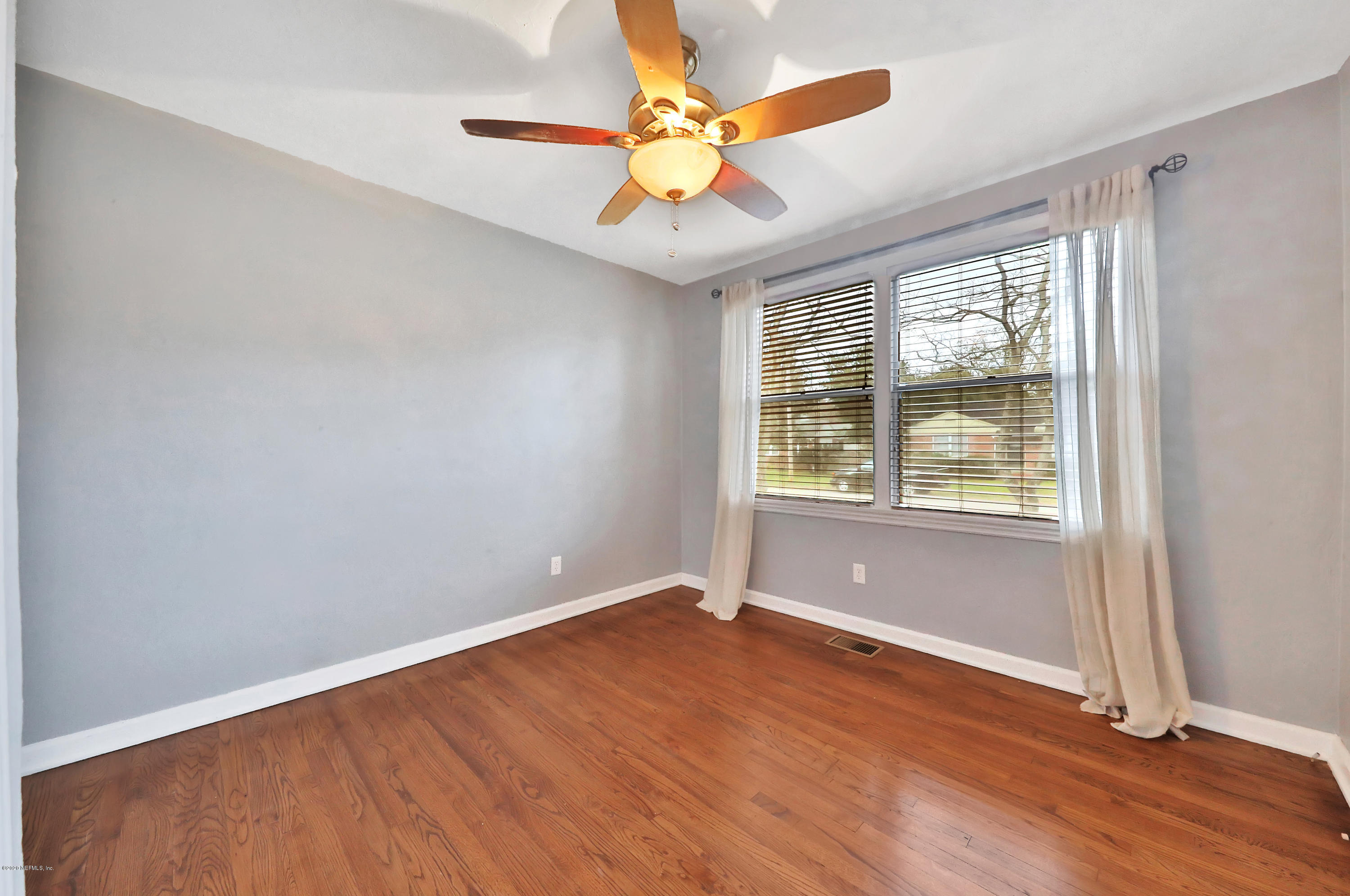 4033 Dover Road Jacksonville, FL 32207 - Photo 21 of 25 an empty room with wooden floor and windows