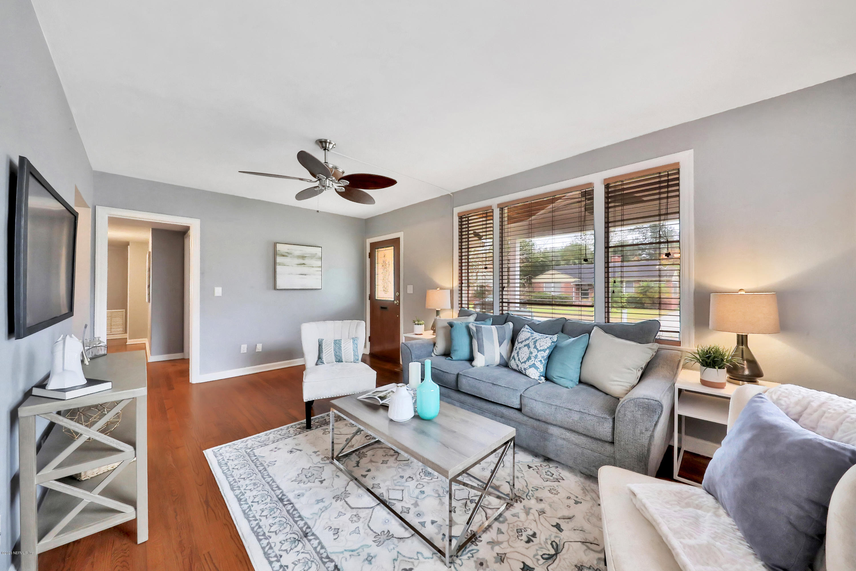 4033 Dover Road Jacksonville, FL 32207 - Photo 7 of 25 a living room with furniture and a flat screen tv with wooden floor