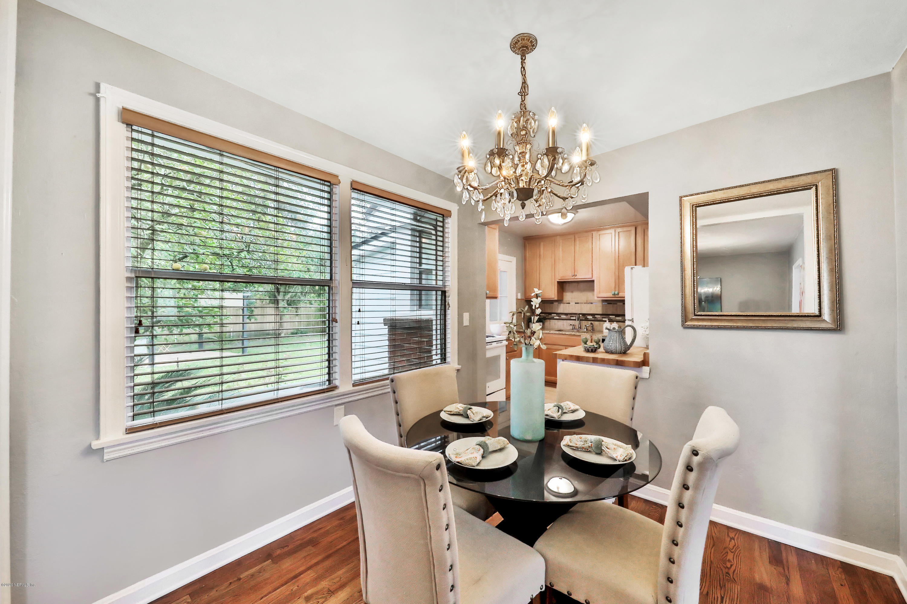 4033 Dover Road Jacksonville, FL 32207 - Photo 9 of 25 a dining room with furniture a rug and a chandelier