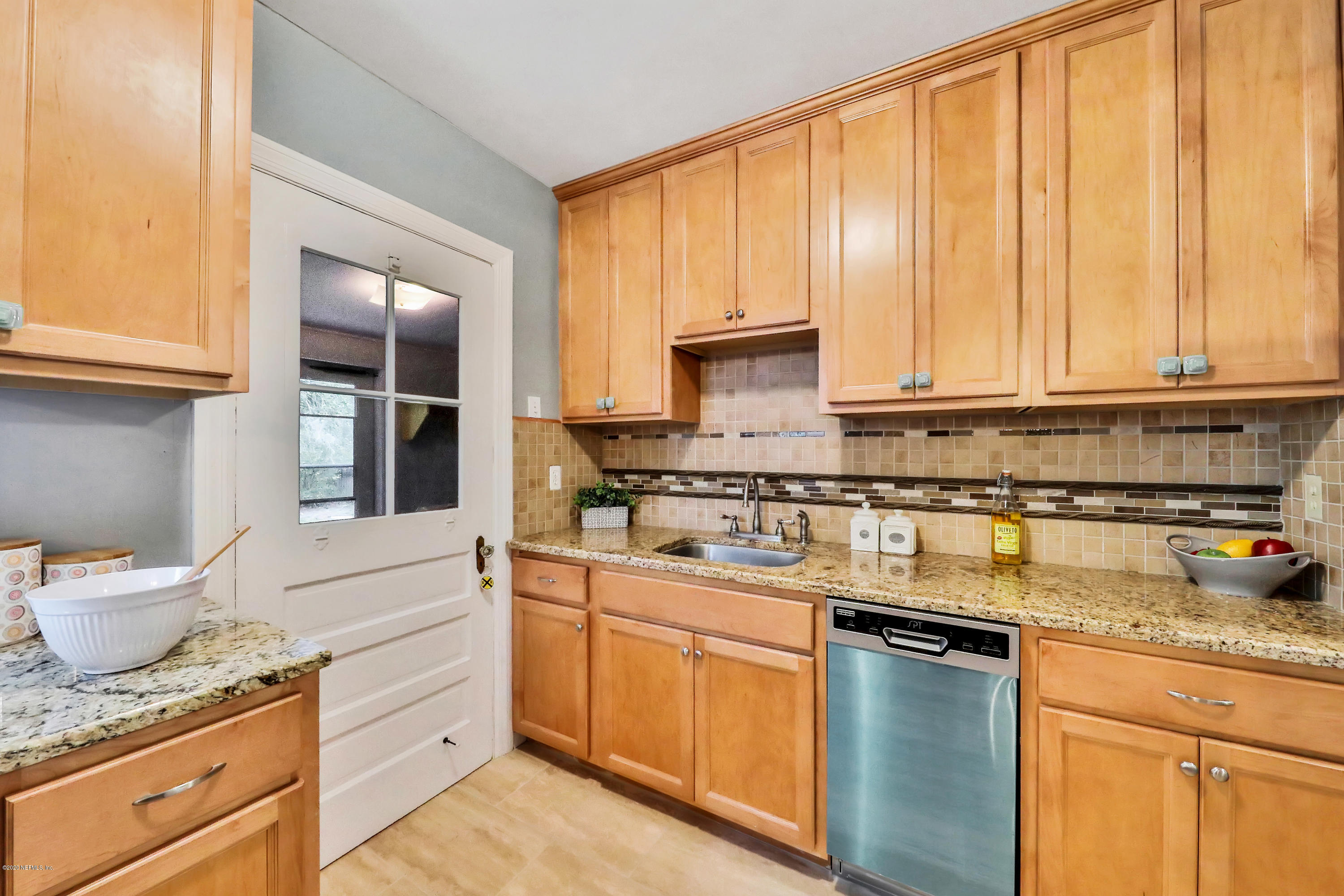 4033 Dover Road Jacksonville, FL 32207 - Photo 10 of 25 a kitchen with stainless steel appliances granite countertop a sink stove and cabinets