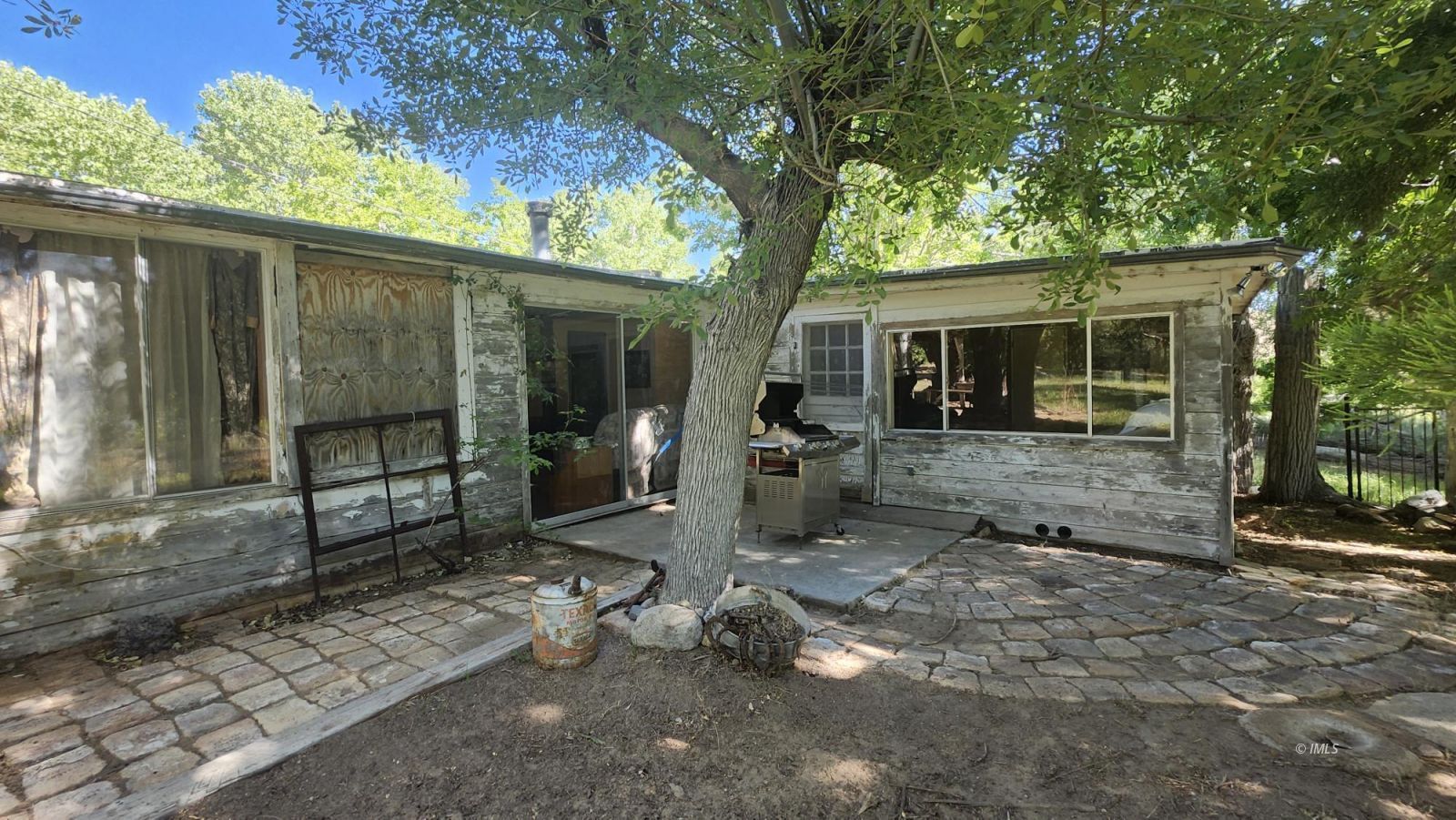 1915 Sage Flats Drive Olancha, CA 93549 - Photo 10 of 34 a backyard of a house with barbeque oven and outdoor seating