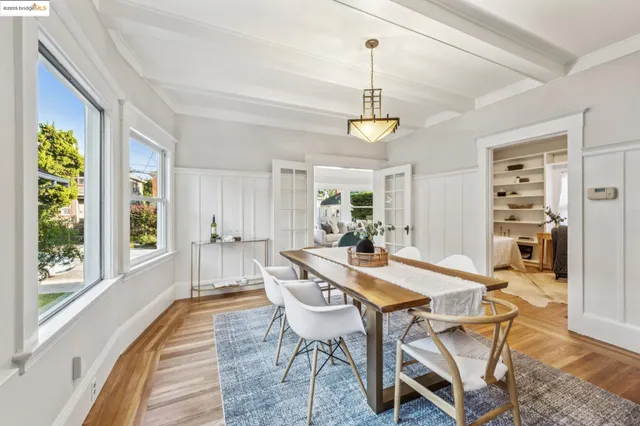 a kitchen with white cabinets and sink
