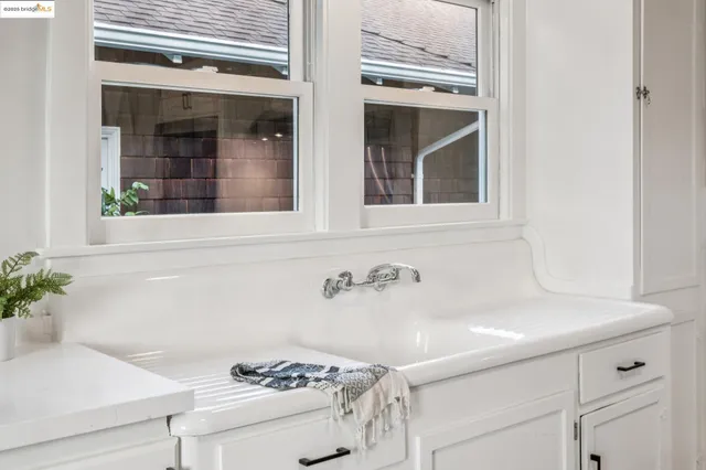 a kitchen with white cabinets and white appliances