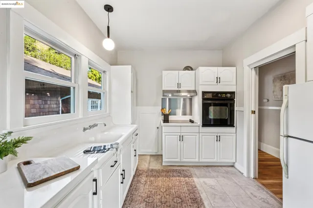a kitchen with a sink a stove and cabinets