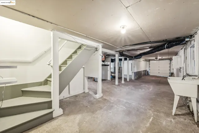 a roof deck with couches and wooden fence