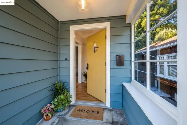 a view of a hallway with wooden floor and furniture