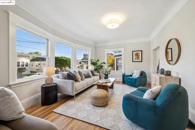 a living room with furniture and a mirror