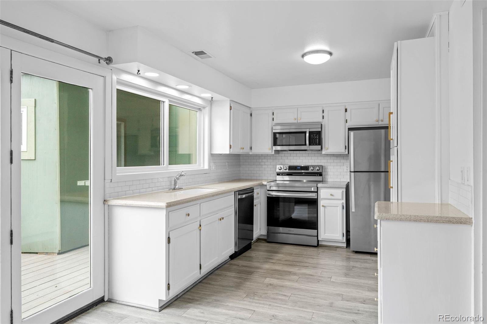 34 Benthaven Place Boulder, CO 80305 - Photo 18 of 40 a kitchen with granite countertop a stove top oven sink and refrigerator