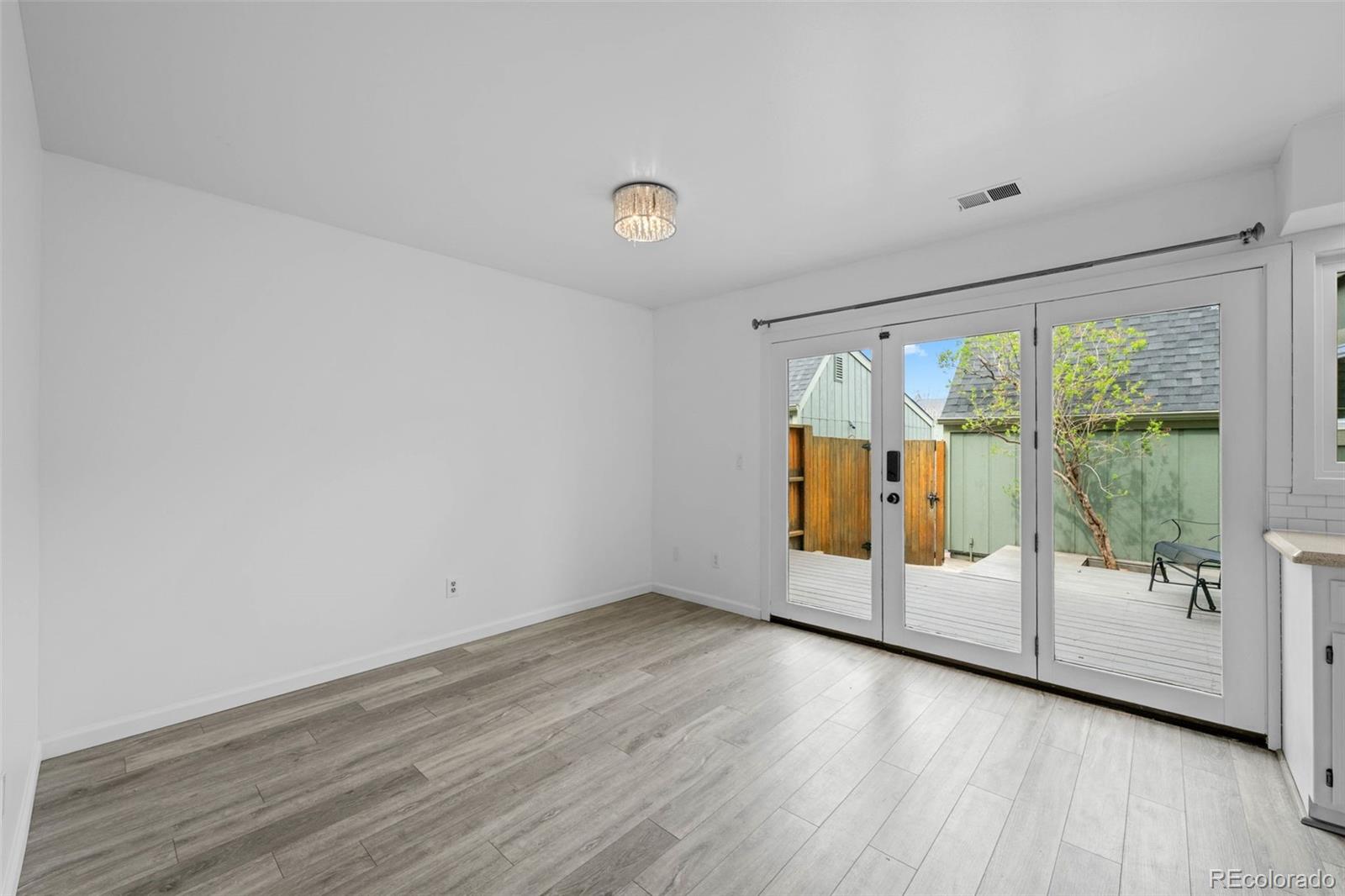 34 Benthaven Place Boulder, CO 80305 - Photo 19 of 40 a view of an empty room with wooden floor and a window