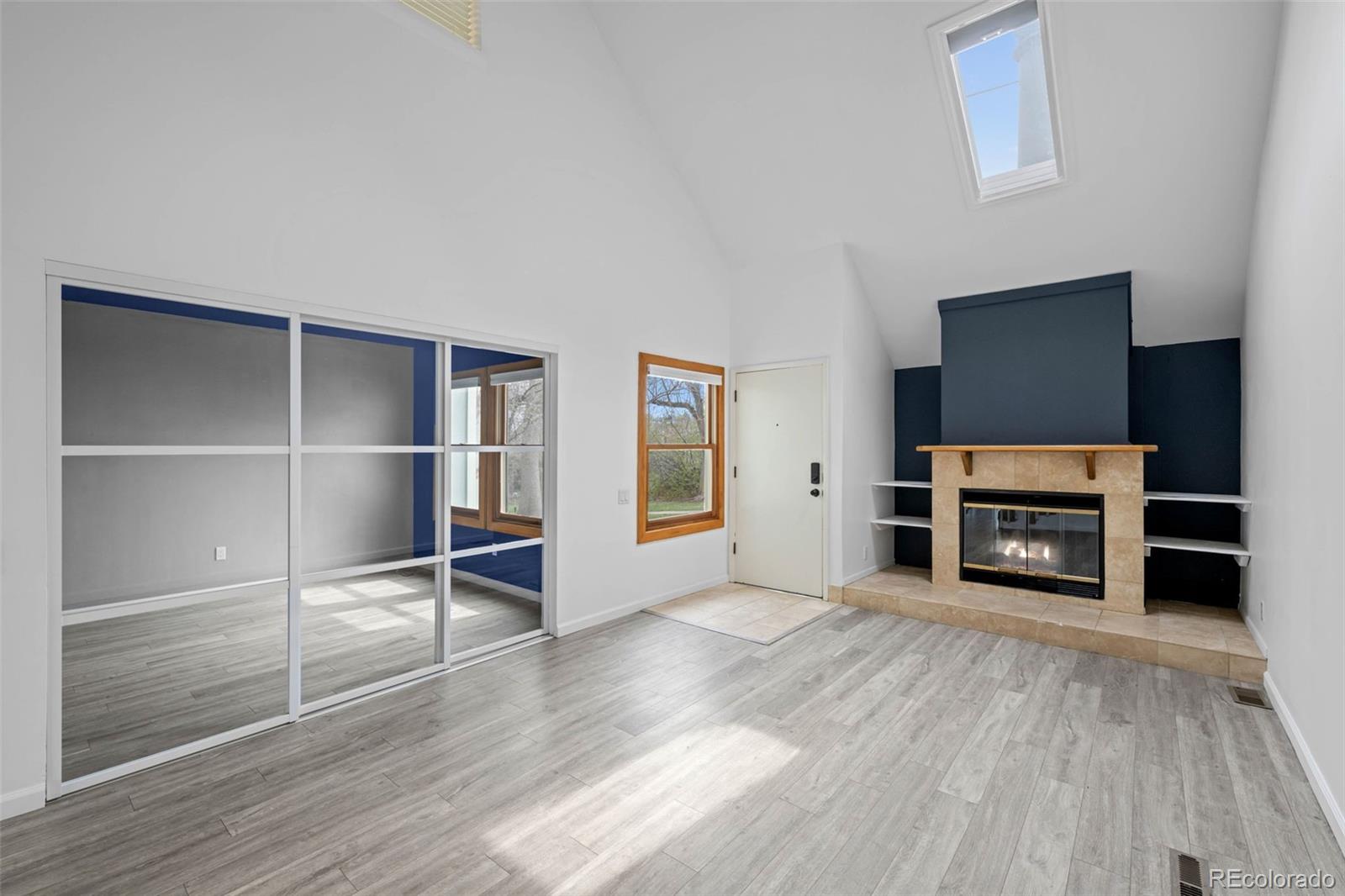 34 Benthaven Place Boulder, CO 80305 - Photo 4 of 40 a view of a livingroom with a flat screen tv wooden floor and staircase