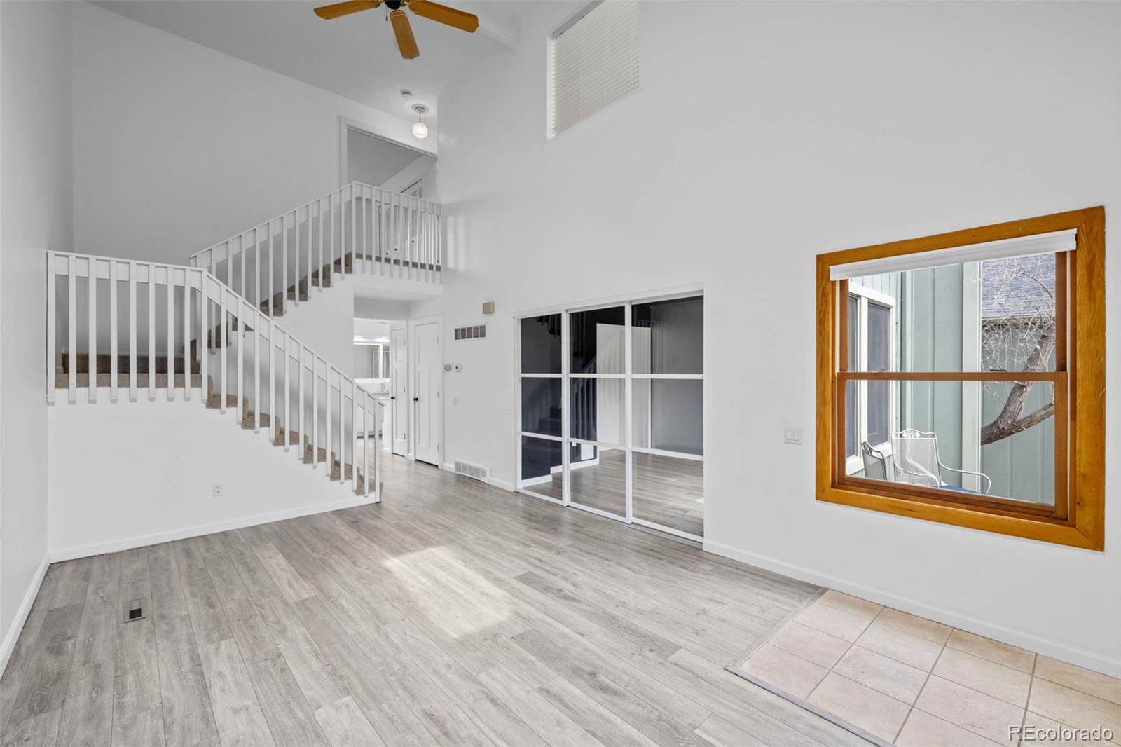 34 Benthaven Place Boulder, CO 80305 - Photo 5 of 40 a view of an empty room with wooden floor and a window