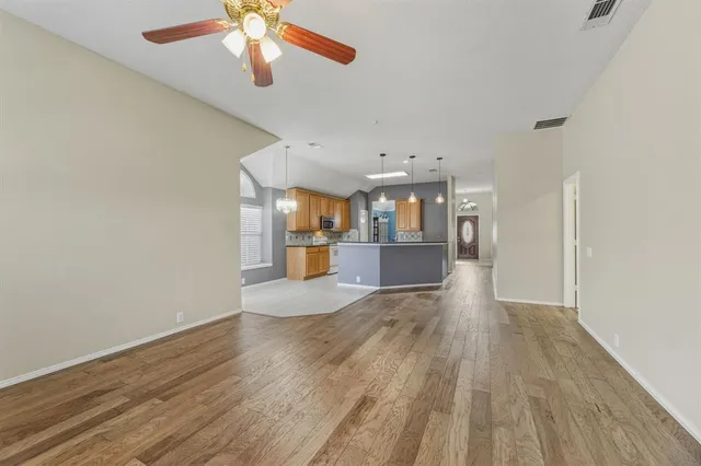 a view of a kitchen with a sink and wooden floor