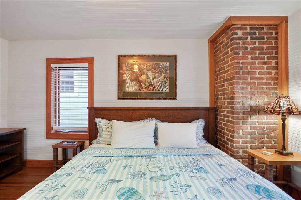 702 Pass A Grille Way St. Pete Beach, FL 33706 - Photo 25 of 41 a bed sitting in a bedroom next to a window