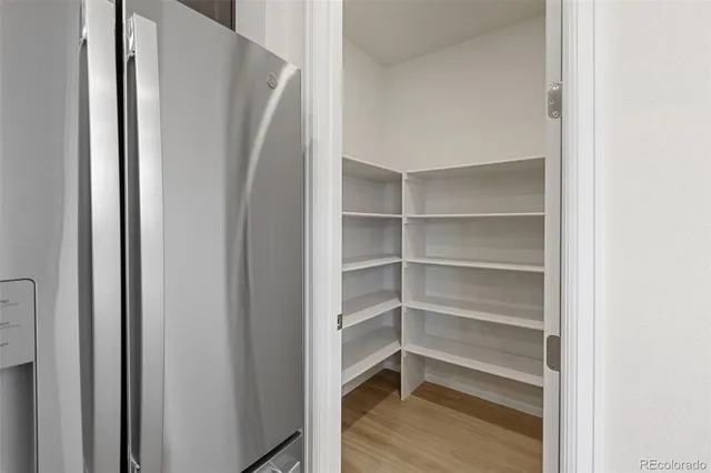a view of walk in closet with empty racks