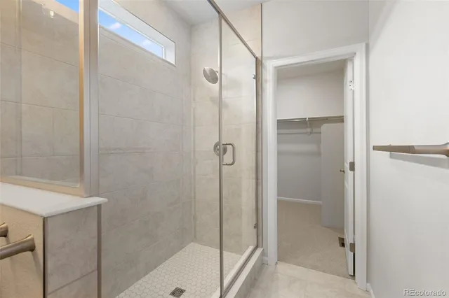 a bathroom with a shower and a bath tub