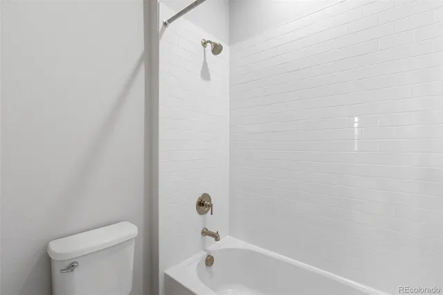 a bathroom with a bathtub and a toilet