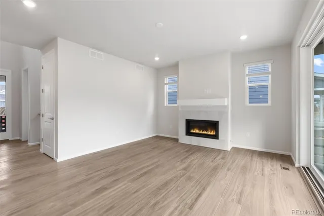a view of a room wooden floor and a fireplace