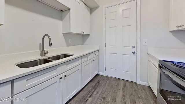 a kitchen with a sink and a refrigerator
