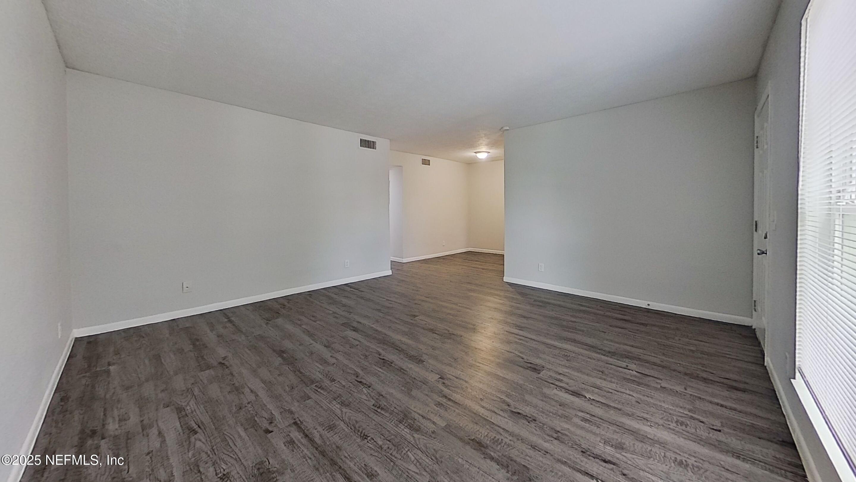 2216 Spring Park Road, Unit 6 Jacksonville, FL 32207 - Photo 14 of 32 a view of an empty room with wooden floor