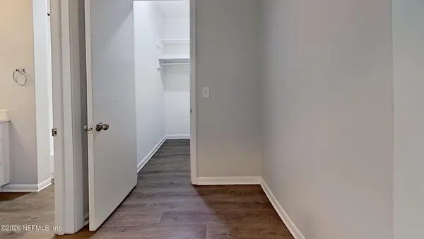 a view of a hallway with wooden floor