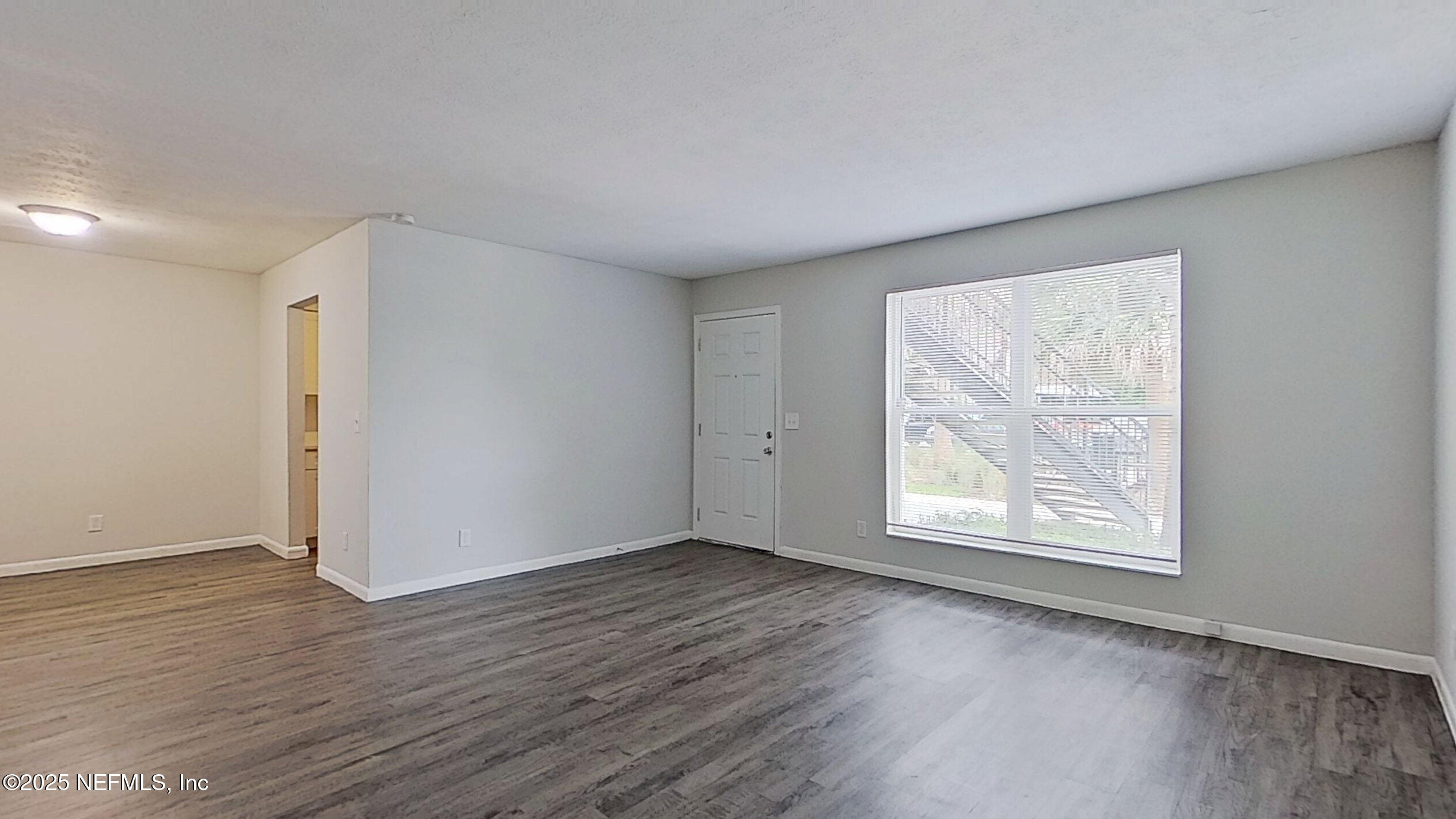 2216 Spring Park Road, Unit 6 Jacksonville, FL 32207 - Photo 17 of 32 an empty room with wooden floor and windows