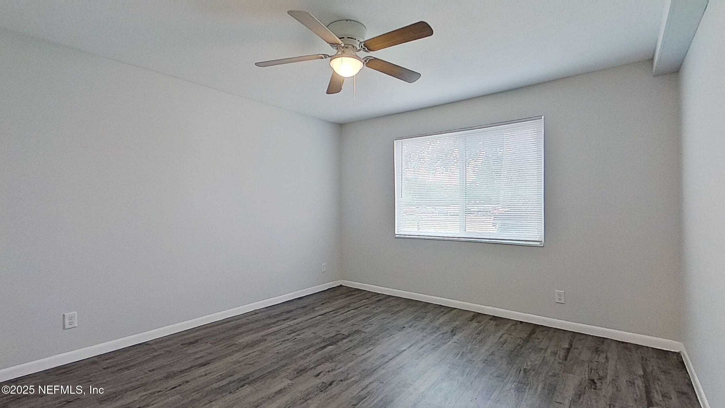 2216 Spring Park Road, Unit 6 Jacksonville, FL 32207 - Photo 22 of 32 an empty room with wooden floor and windows