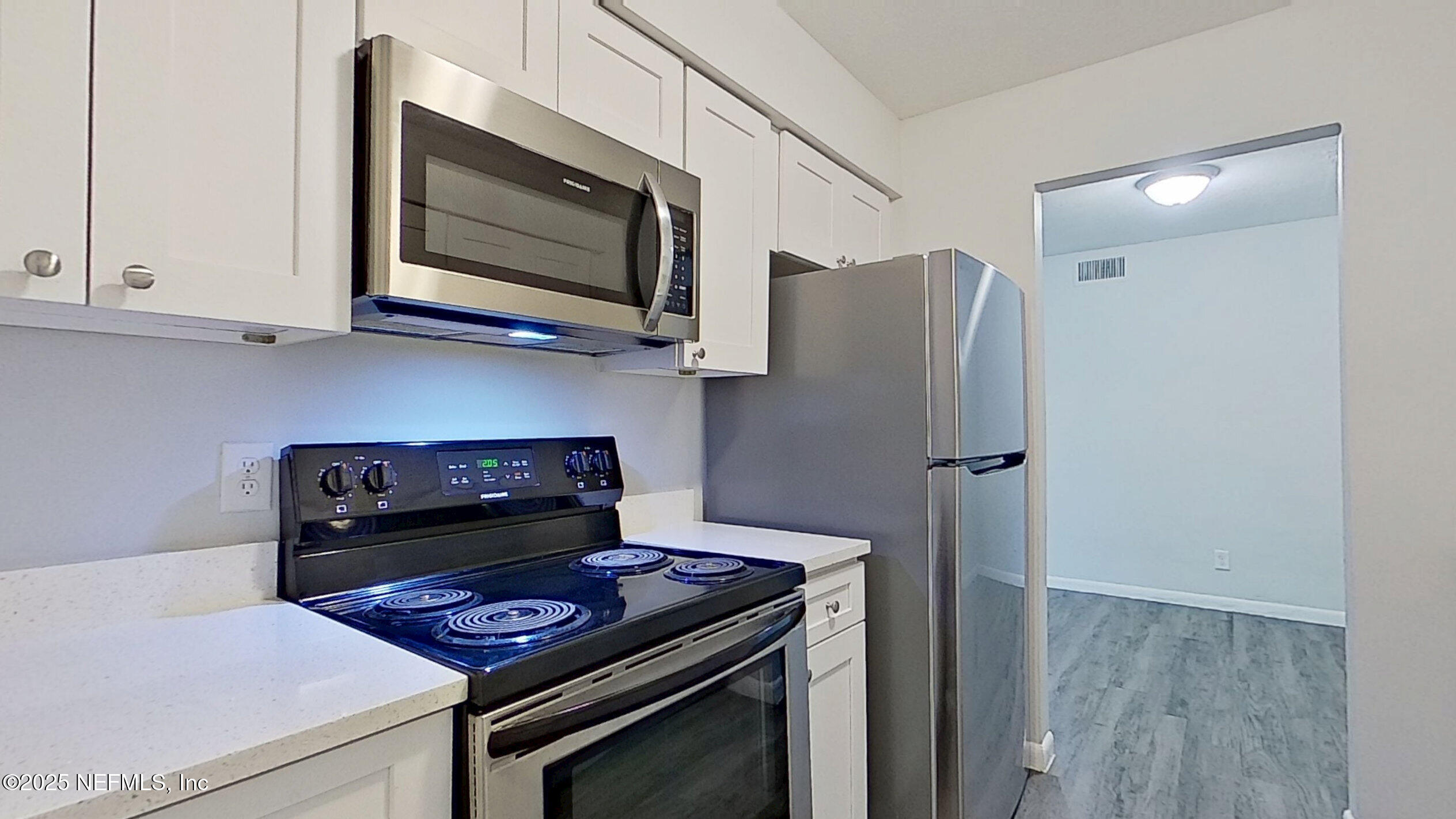 2216 Spring Park Road, Unit 6 Jacksonville, FL 32207 - Photo 9 of 32 a kitchen with a stove and a microwave