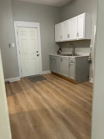a view of kitchen with white cabinets