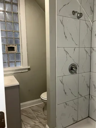 a bathroom with a toilet and shower