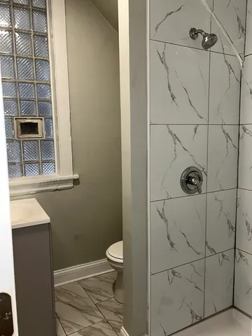 a bathroom with a toilet and shower