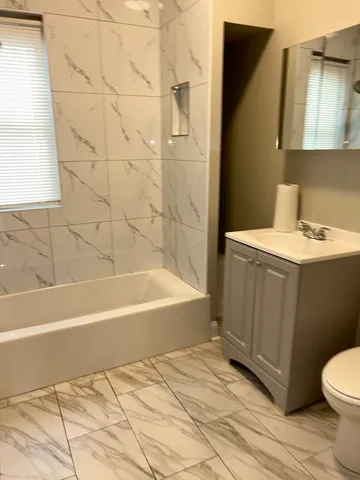 a bathroom with a sink a toilet and bathtub