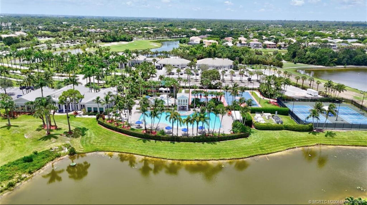 2261 Ridgewood Circle Royal Palm Beach, FL 33411 - Photo 12 of 12 a view of a lake with a house