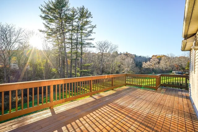 a view of balcony with wooden floor and fence