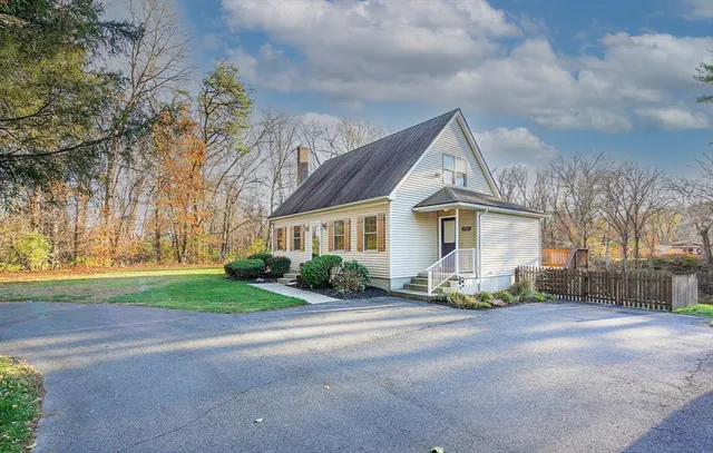 a front view of house with yard and green space