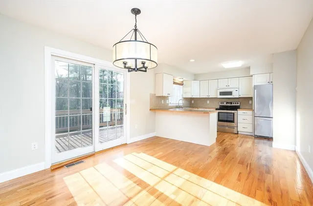a open kitchen with stainless steel appliances granite countertop a stove and refrigerator