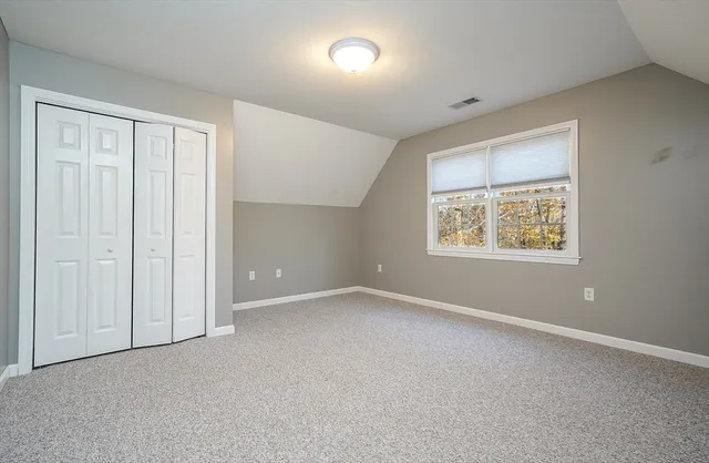 an empty room with windows and closet