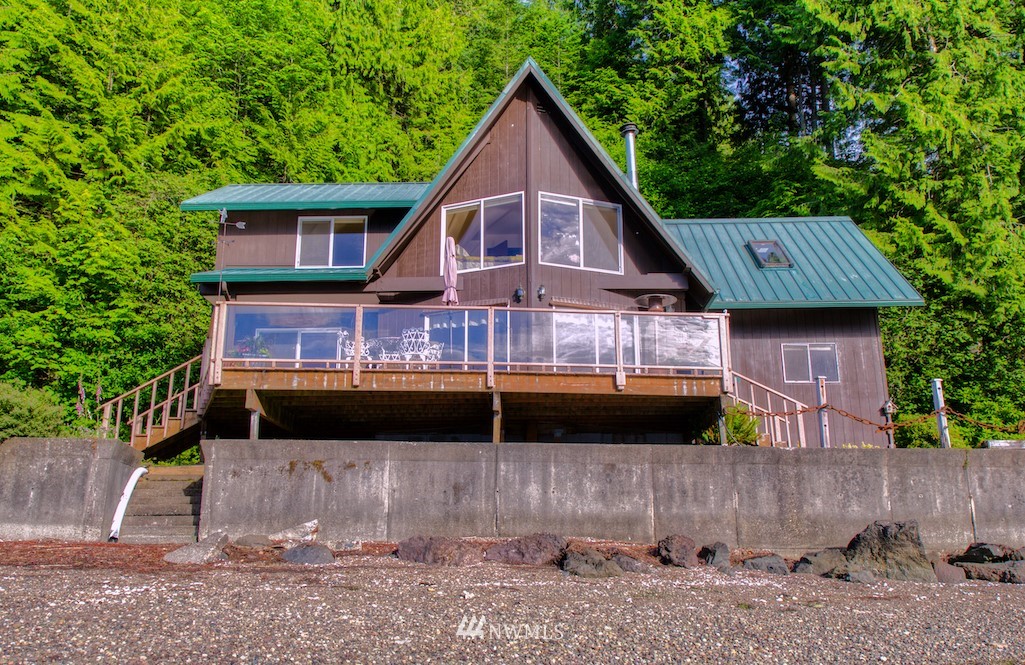 3370 East Quilcene Road Quilcene, WA 98376 - Photo 2 of 34 a front view of a house with a yard