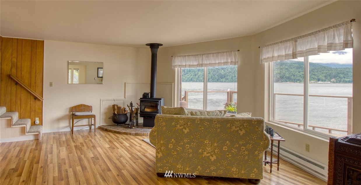 3370 East Quilcene Road Quilcene, WA 98376 - Photo 12 of 34 a living room with furniture and large windows