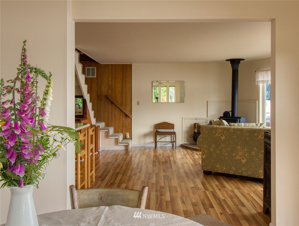 3370 East Quilcene Road Quilcene, WA 98376 - Photo 15 of 34 a living room with furniture and flowers