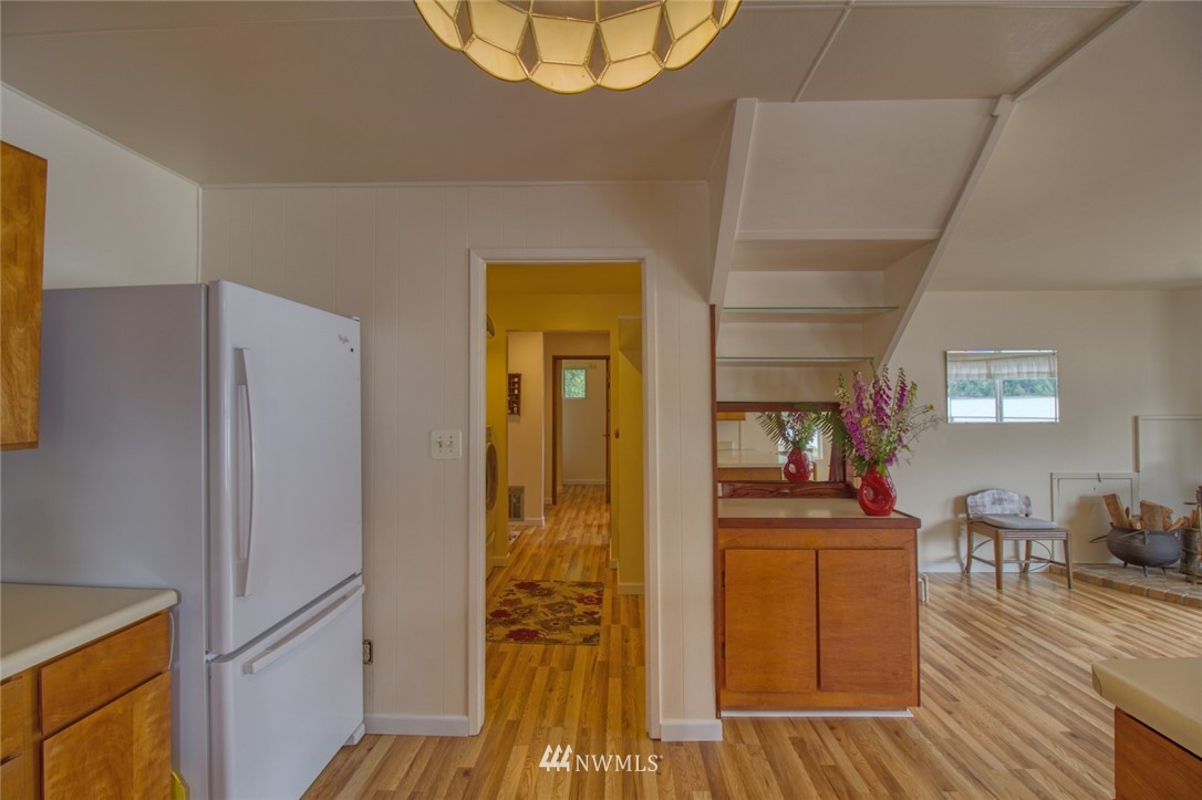 3370 East Quilcene Road Quilcene, WA 98376 - Photo 16 of 34 a view of a living room and bathroom with a wooden floor