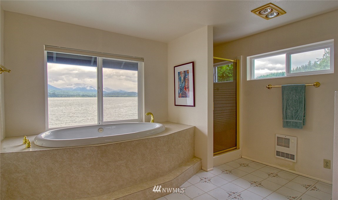 3370 East Quilcene Road Quilcene, WA 98376 - Photo 22 of 34 a spacious bedroom with a bed and a window