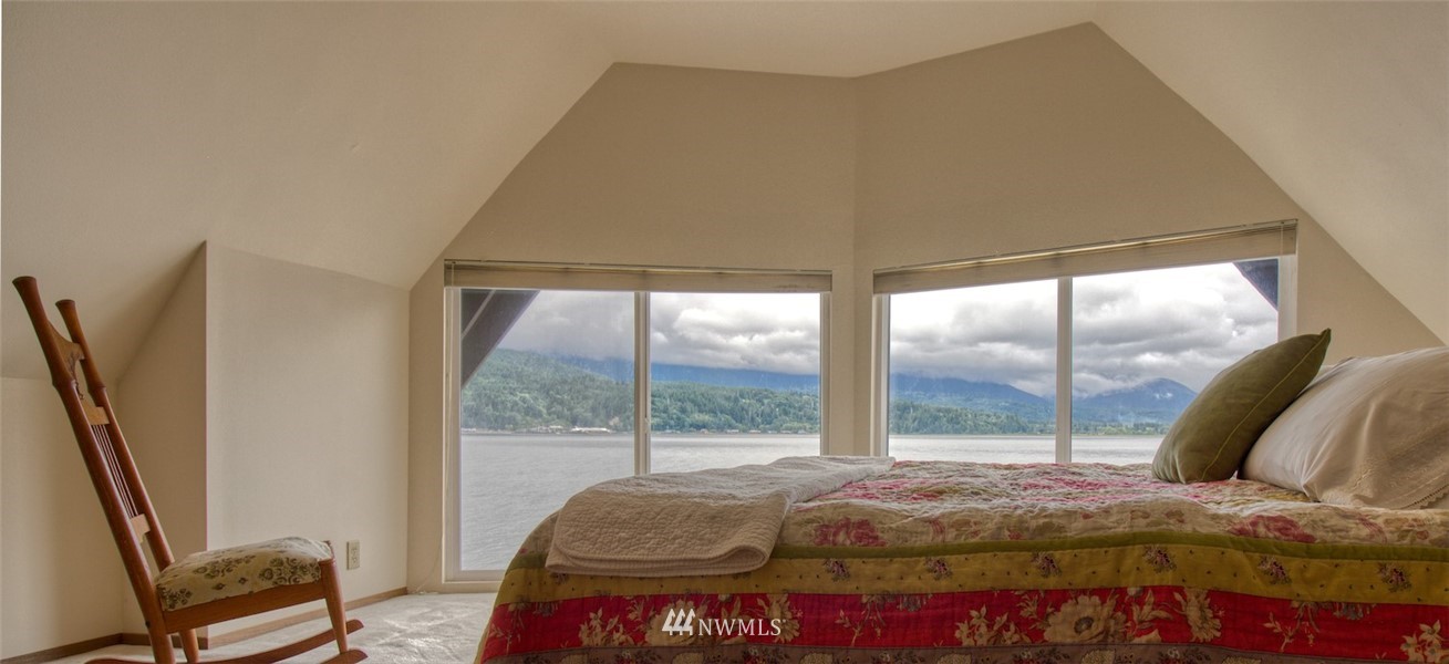3370 East Quilcene Road Quilcene, WA 98376 - Photo 23 of 34 a bedroom with a bed and large window