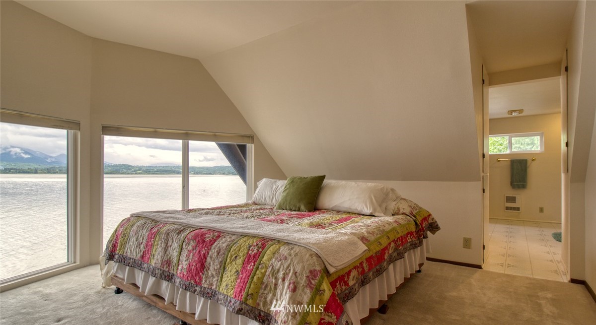 3370 East Quilcene Road Quilcene, WA 98376 - Photo 24 of 34 a bedroom with a bed and a large window