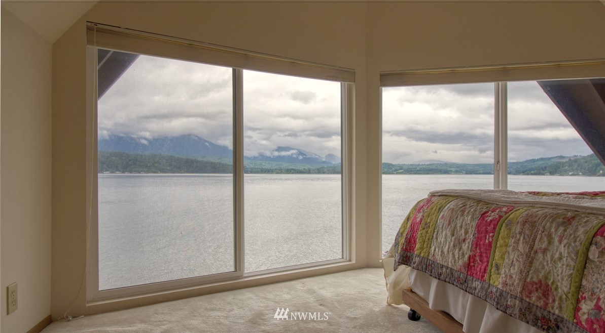 3370 East Quilcene Road Quilcene, WA 98376 - Photo 26 of 34 a bed sitting in a bedroom next to a window